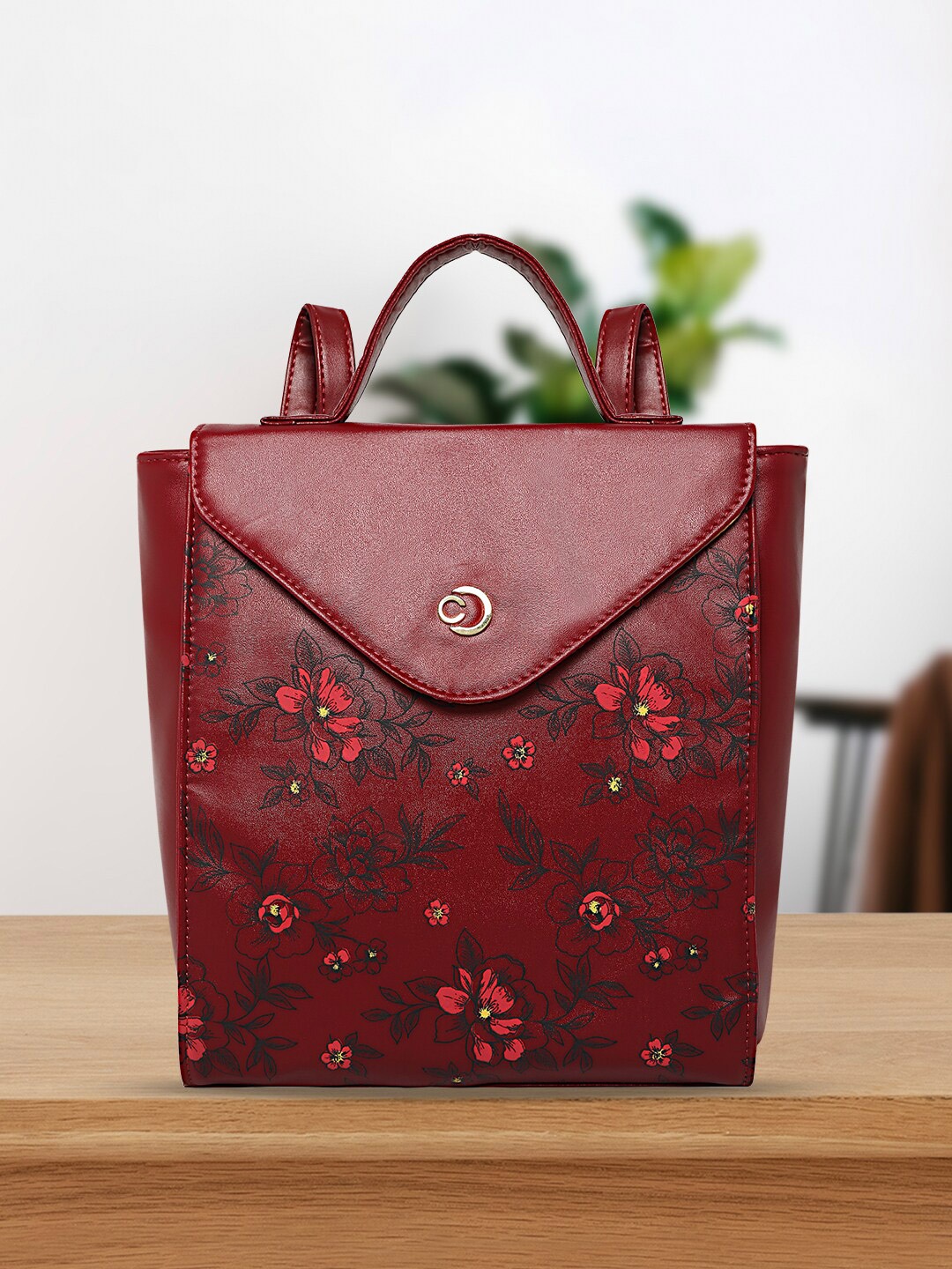 

Caprese Women Graphic Printed Medium Backpack, Maroon