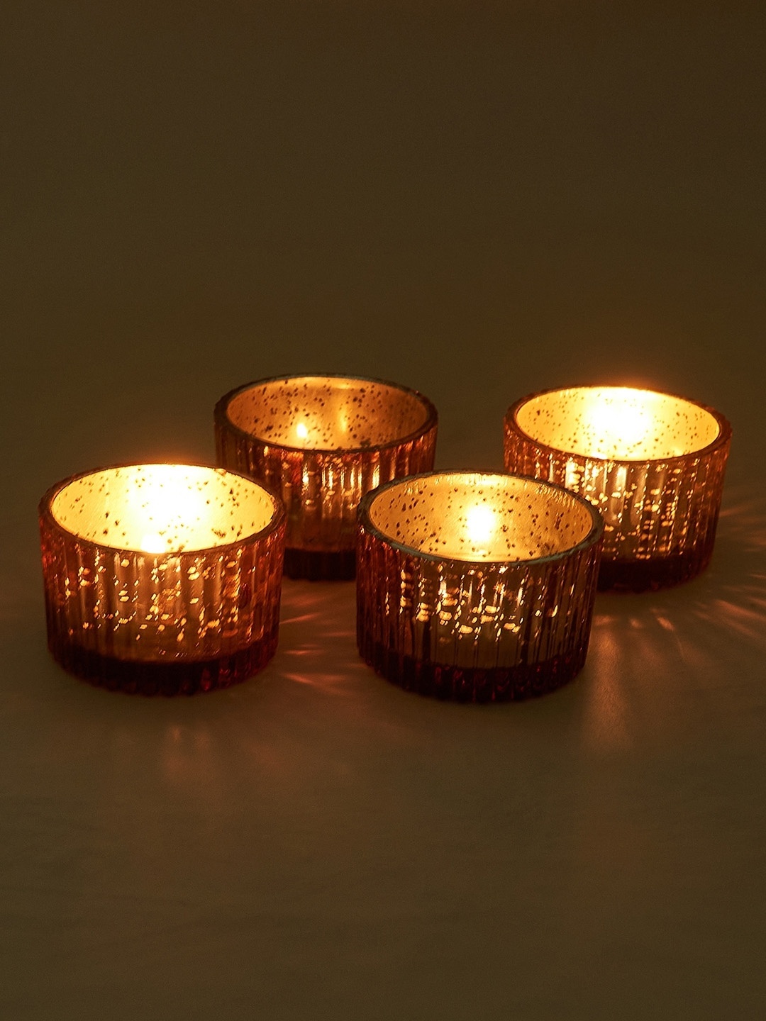 

NURTURE INDIA Copper Toned 4 Pieces Candle Holder