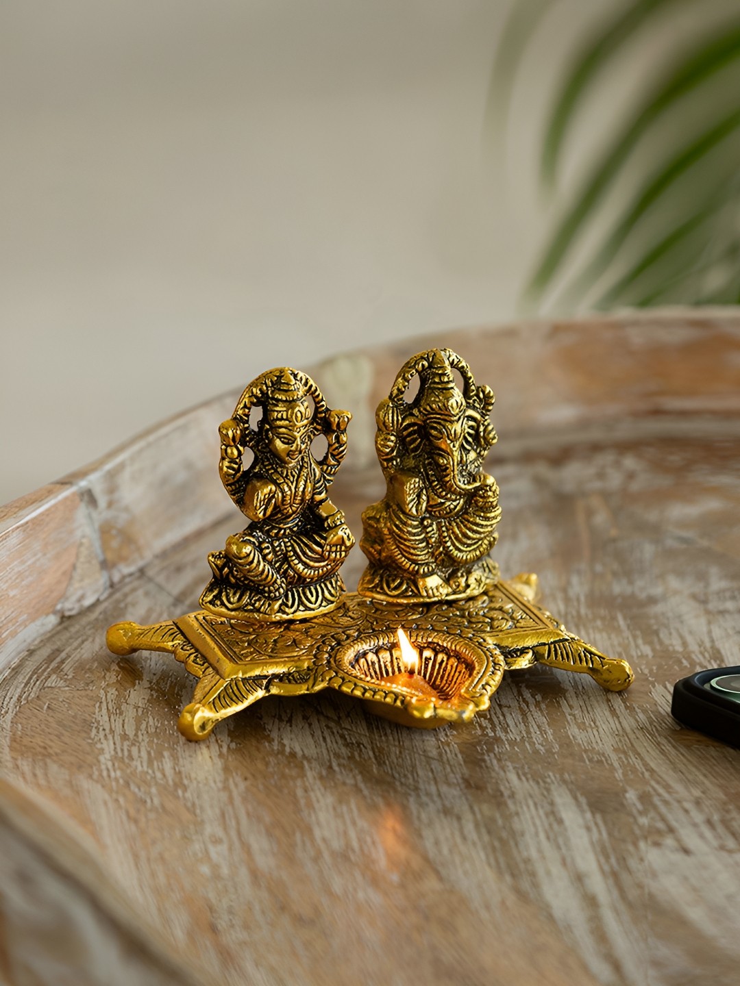 

ExclusiveLane Gold Toned Divine Laxmi Ganesh Idol & Diya Decorative Showpiece Figurine