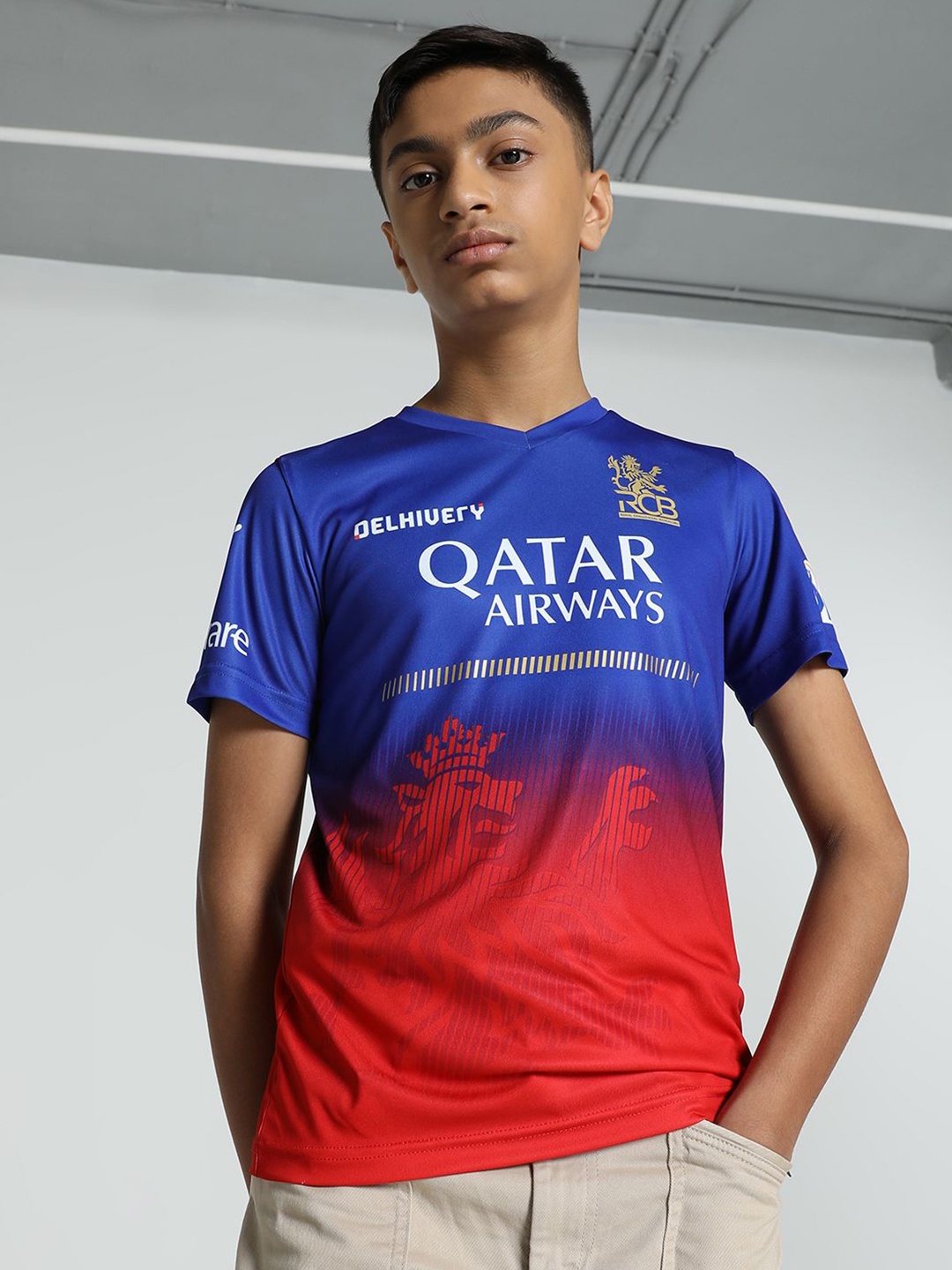 

Puma x RCB 2024 Boys Printed V-Neck Tshirt, Blue
