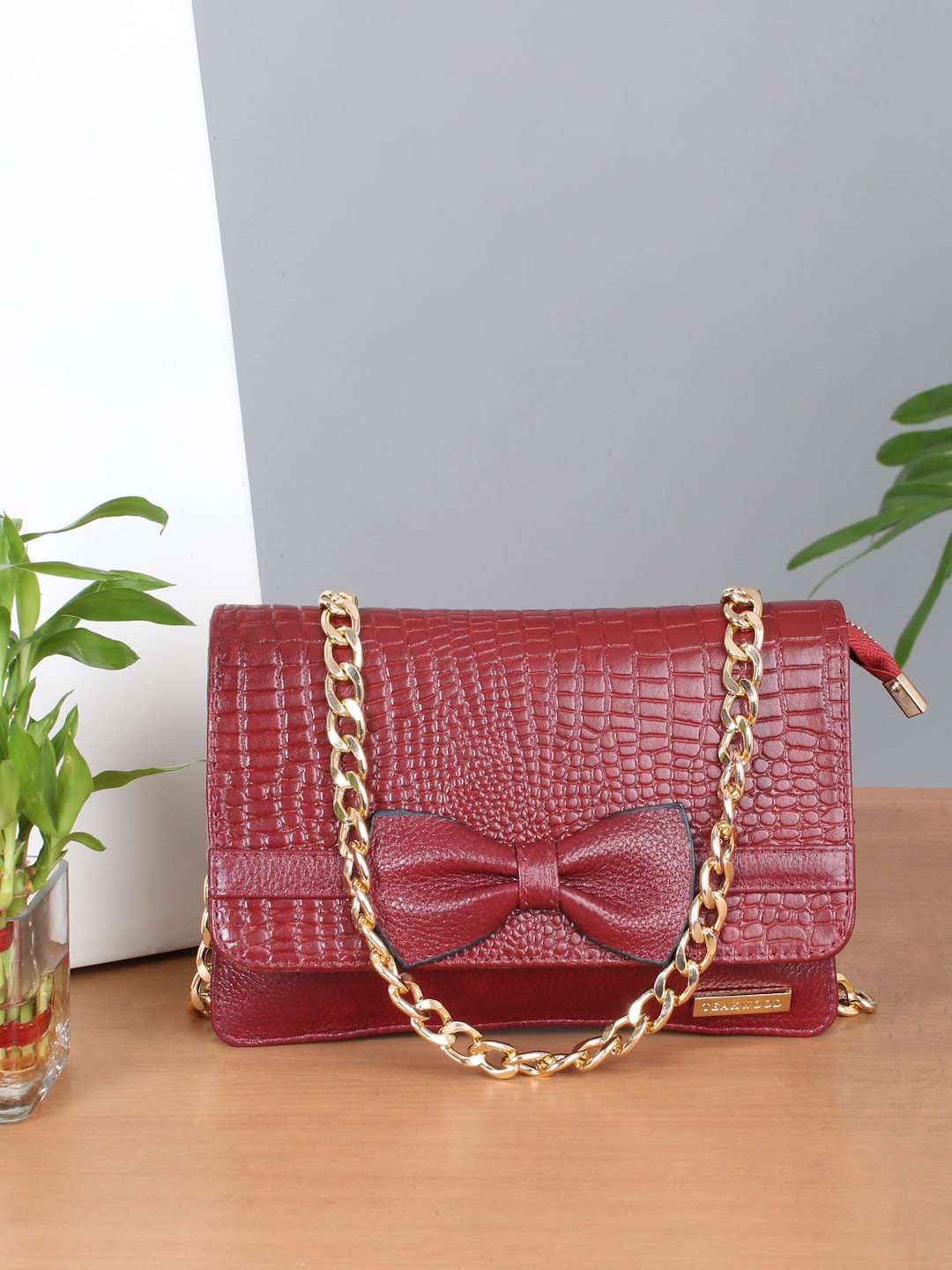 

Teakwood Leathers Textured Structured Sling Bag with Bow Detail, Red