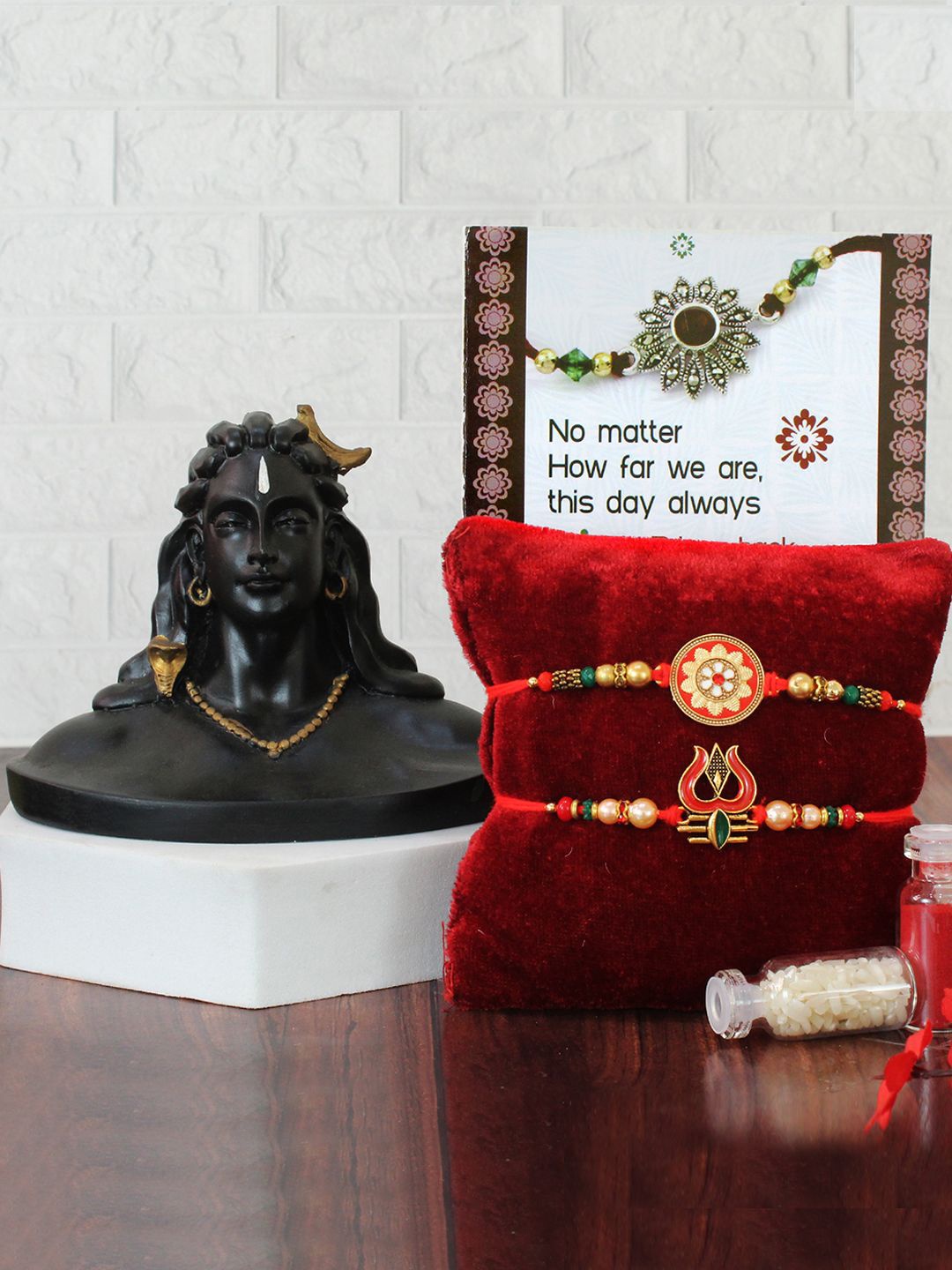 

TIED RIBBONS Set of 2 Trishul Rakhi With Adiyogi Shiva Idol Greeting Card & Roli ChawalSet, Red