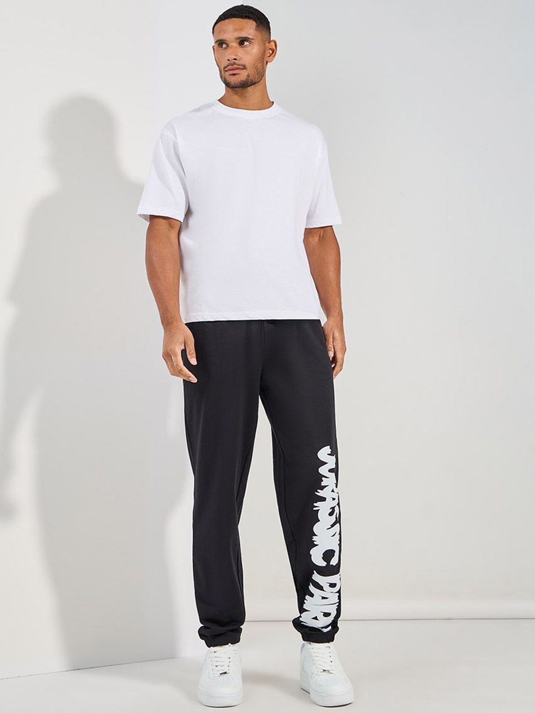 

Styli Men Black Jurrasic Park Graphic print Oversized Open Hem Terry Joggers