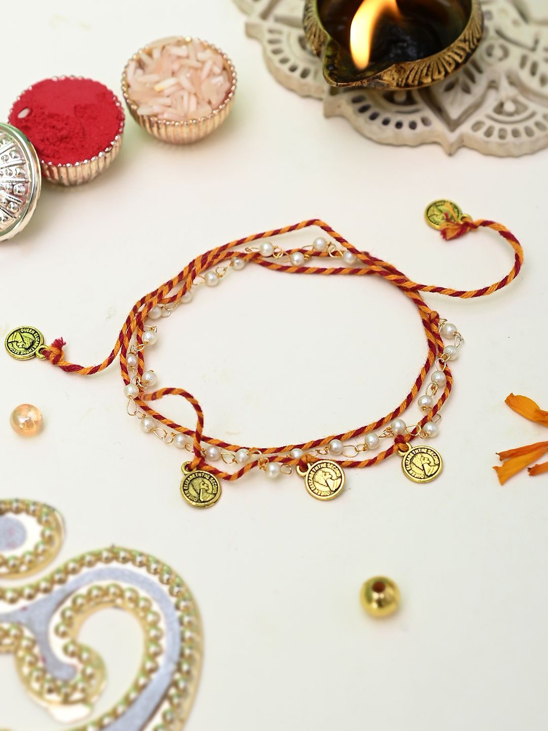 

Aapno Rajasthan Pearl & Metal Coins Braided Rakhi, Gold