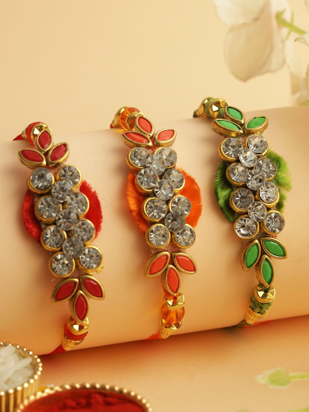 

Aapno Rajasthan Set of 3 Stone-Studded Rakhi with Roli Chawal & Greeting Card, Red