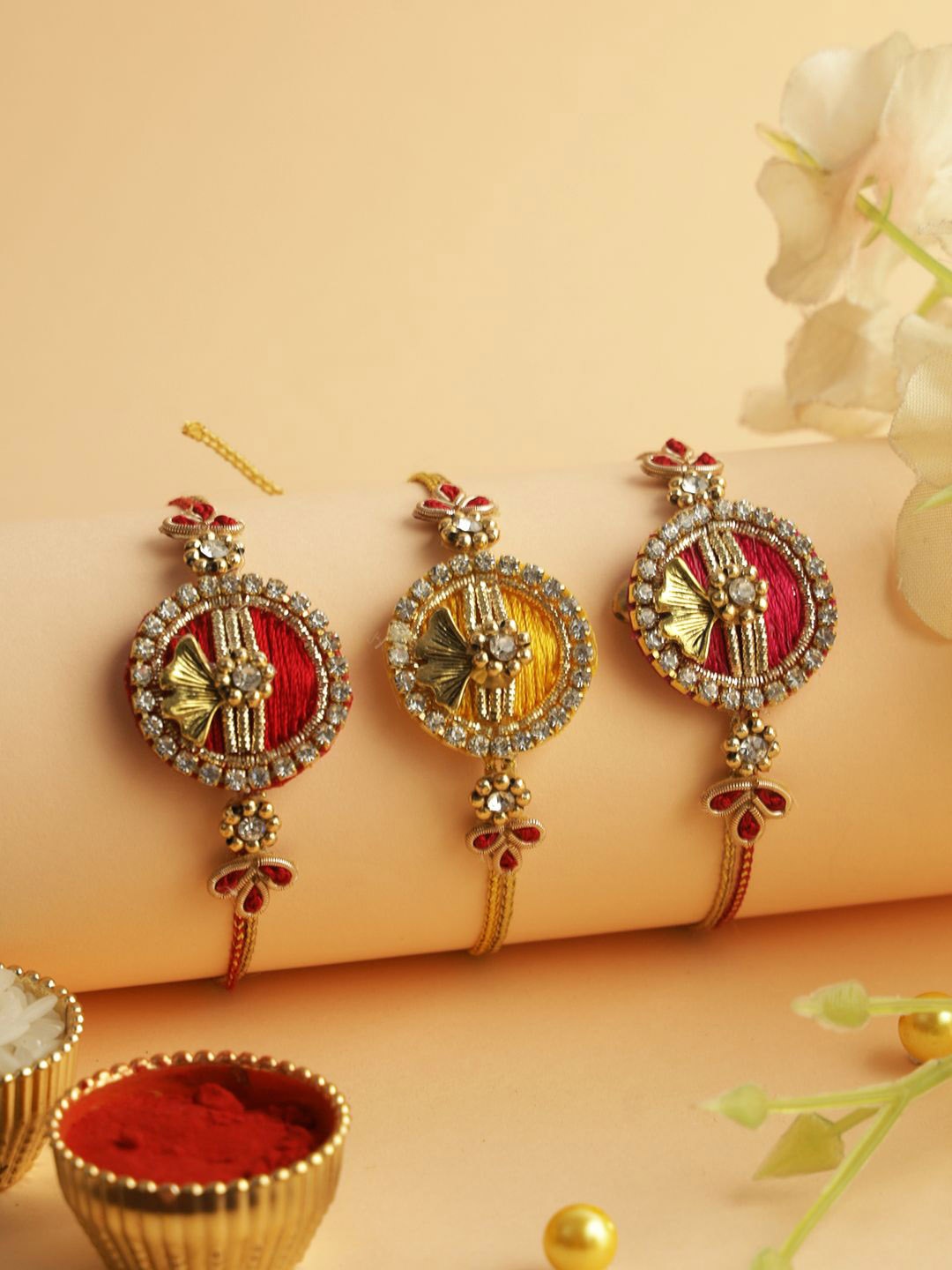 

Aapno Rajasthan Set Of 3 Stone Studded Rakhis With Roli Chawal & Greeting Card, Gold