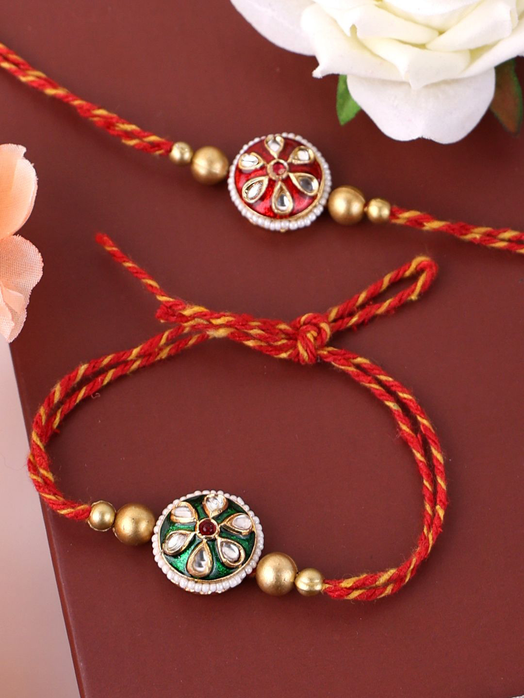 

PANASH- Unisex Gold Plated Set Of 2 Floral Shaped Thread Rakhis With Roli Chawal