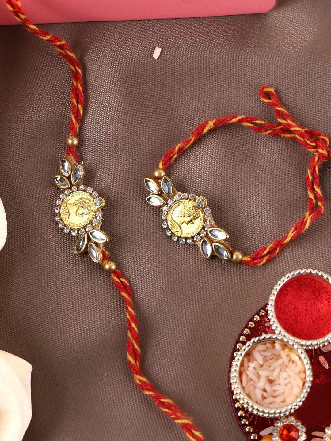 

PANASH Unisex Set of 2 Gold Plated Stone Studded Thread Rakhis & Roli Chawal