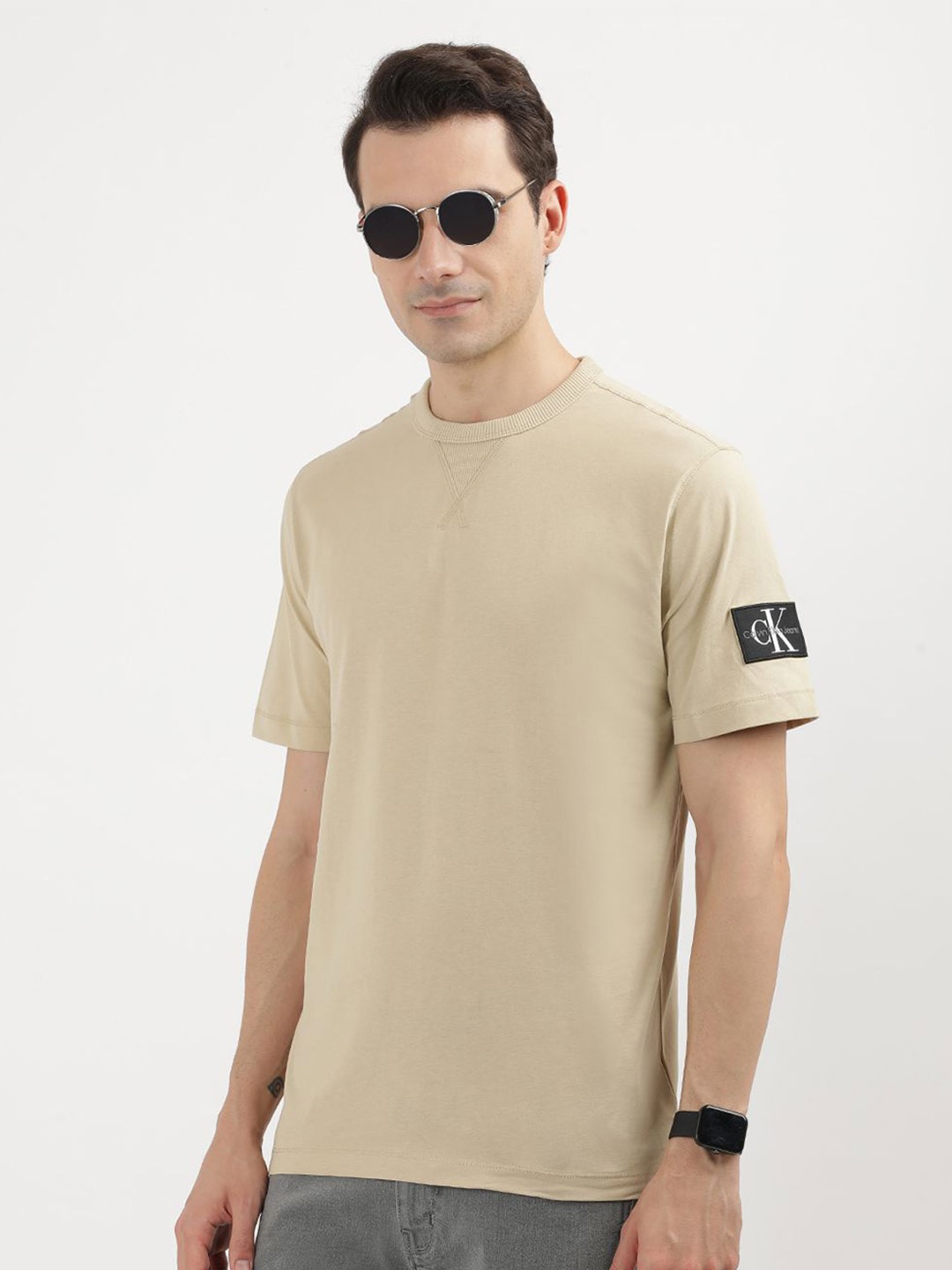 

Calvin Klein Jeans Men Solid Round Neck Applique T-shirt, Beige