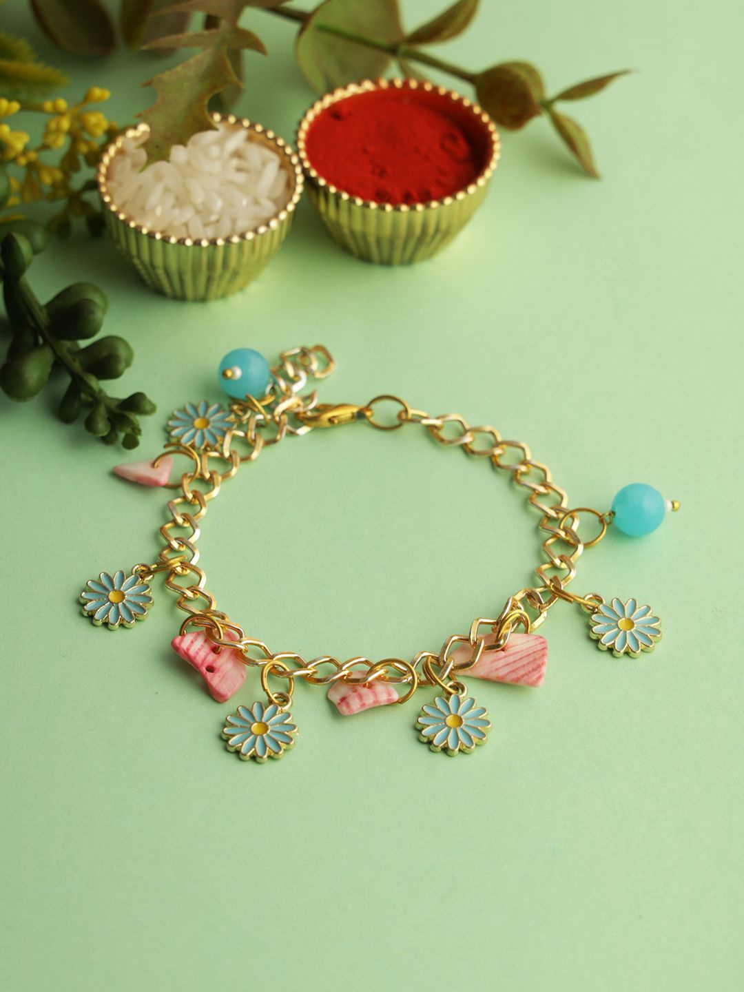 

Aapno Rajasthan Floral Charm Bracelet Rakhi with Roli Chawal & Greetings Card, Gold