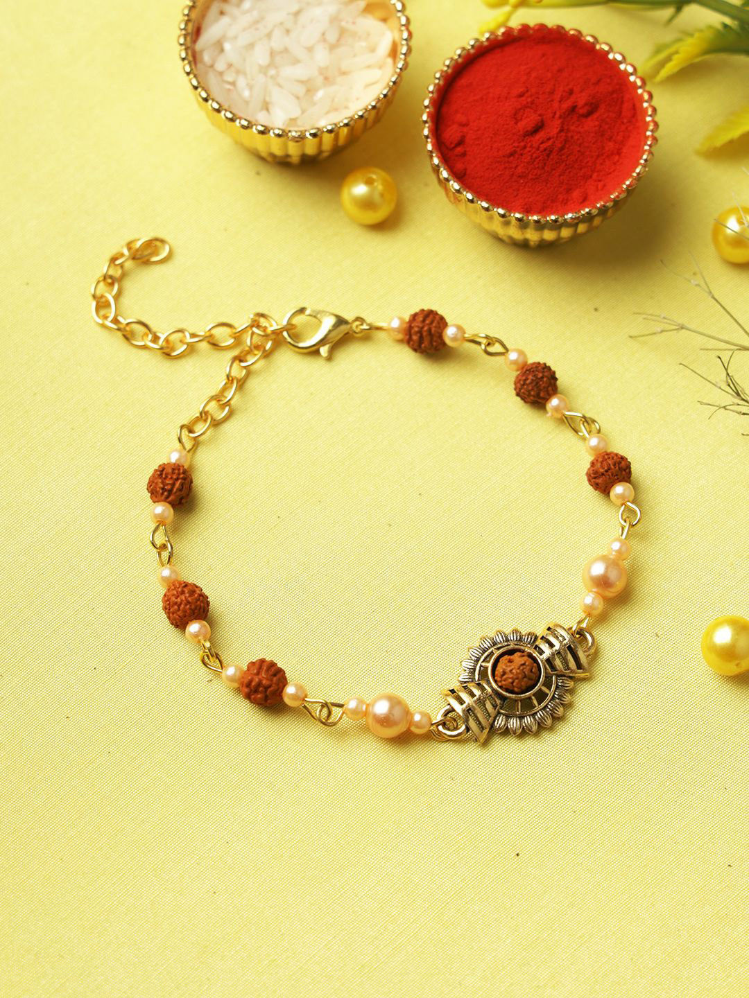 

Aapno Rajasthan Rudraksh Pearl Rakhi with Roli Chawal & Greetings Card, Gold