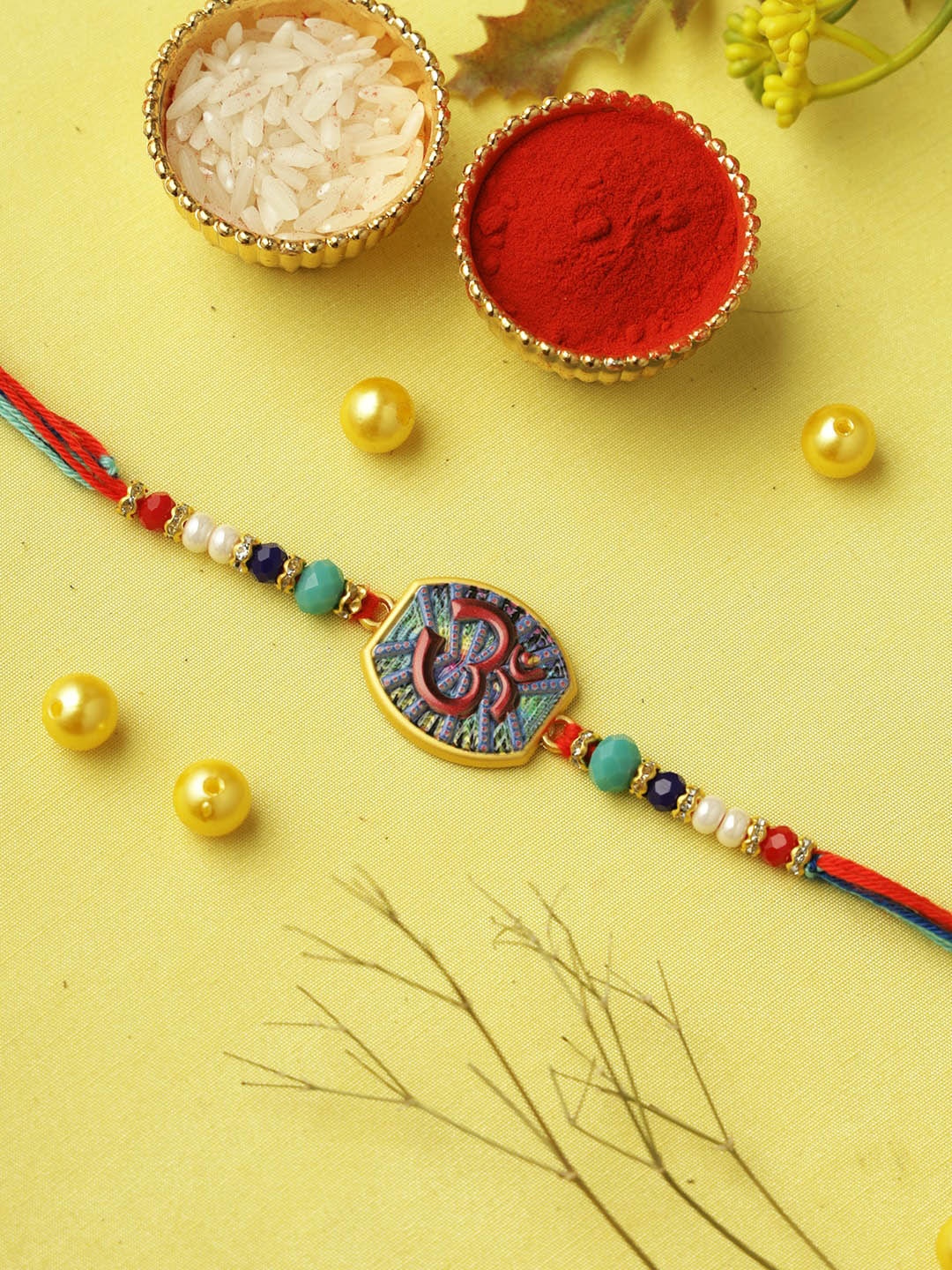 

Aapno Rajasthan Om Beaded Rakhi with Roli Chawal & Greeting Card, Red