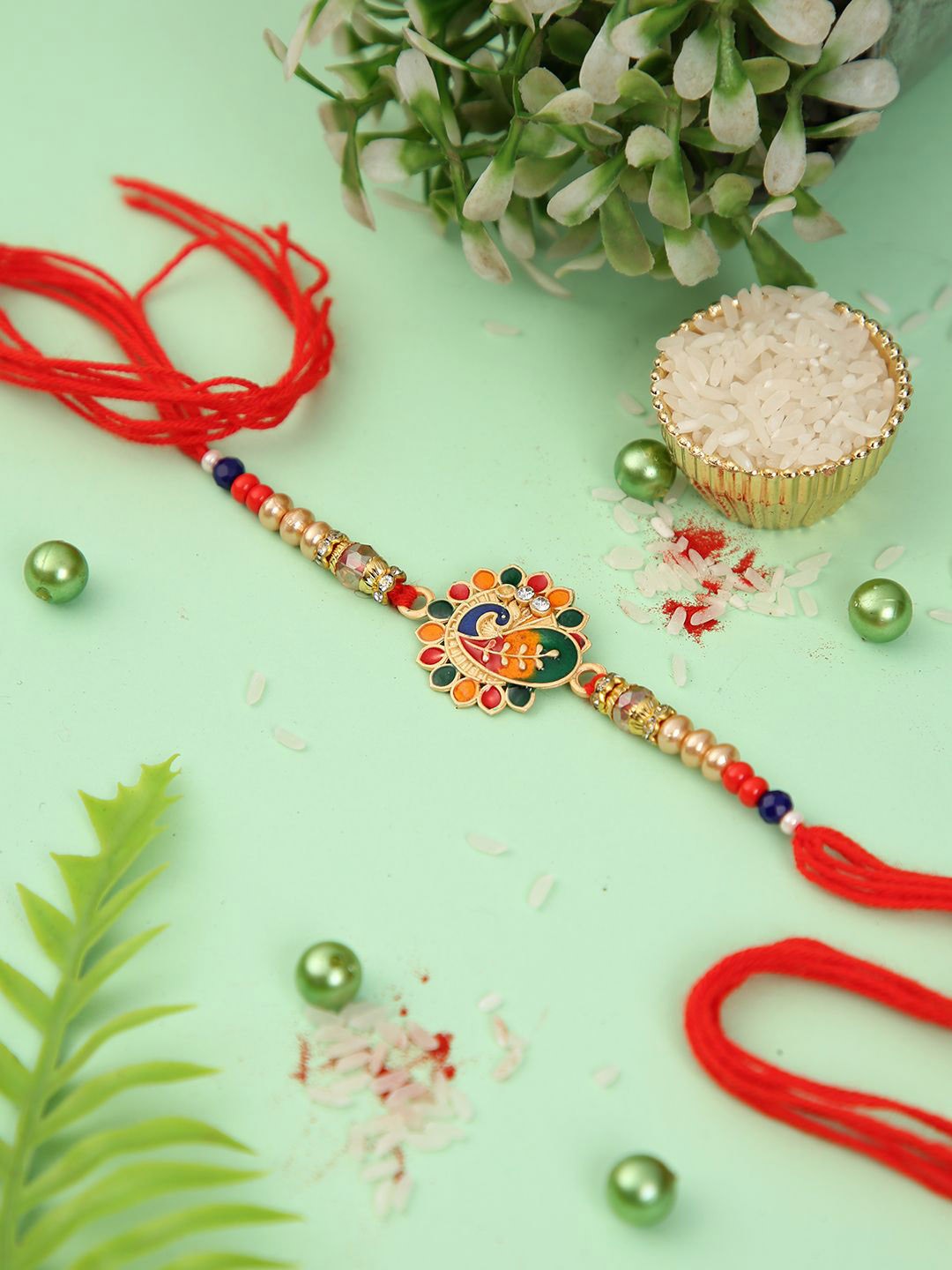 

Aapno Rajasthan Gemstone Peacock Rakhi With Roli Chawal & Greetings Card, Gold