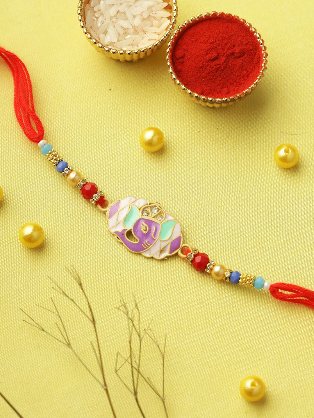 

Aapno Rajasthan Ganesha Pearl Beaded Rakhi With Roli Chawal & Greetings Card, Red