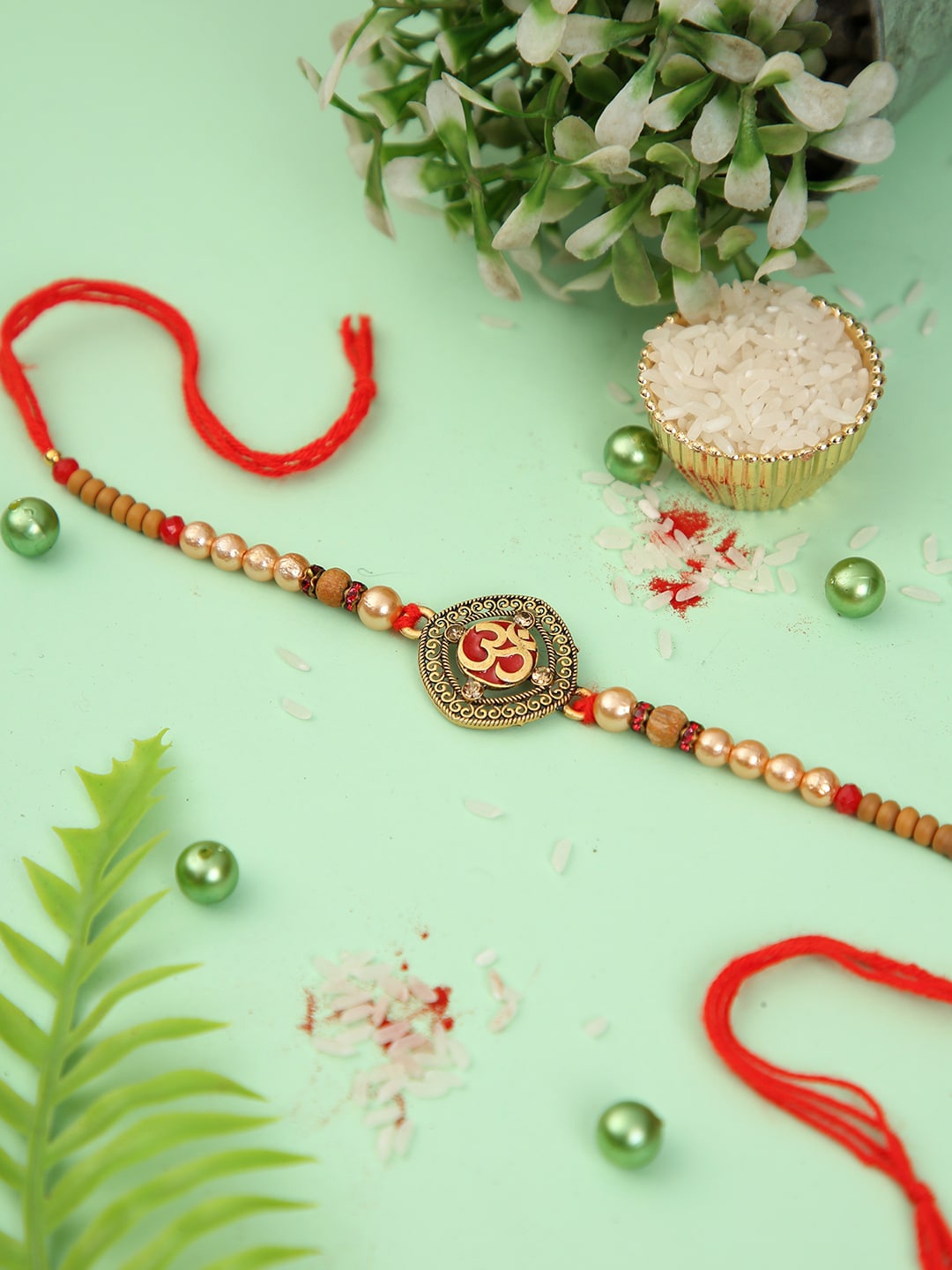 

Aapno Rajasthan Om Divine Beaded Rakhi with Roli Chawal & Greeting Card, Red