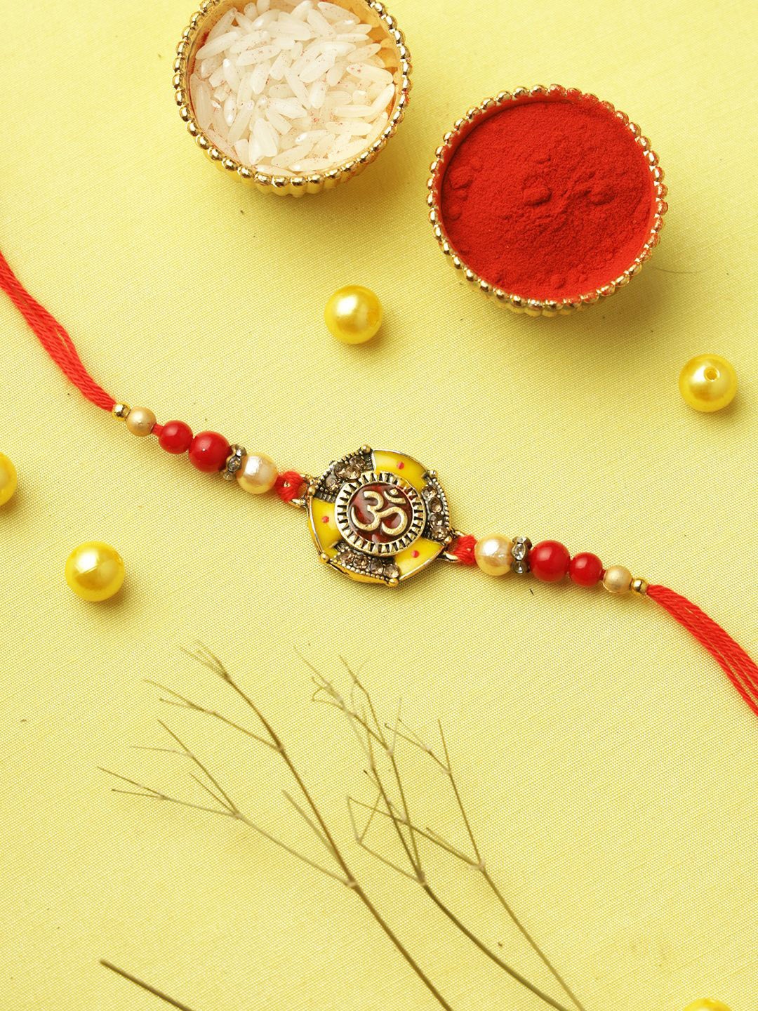 

Aapno Rajasthan Enameled Om Symbol Rakhi with Roli Chawal & Greeting Card, Red