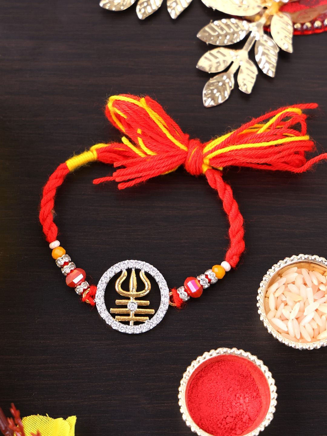 

PANASH Gold Plated Trident Shaped Beaded Thread Rakhi With Roli Chawal
