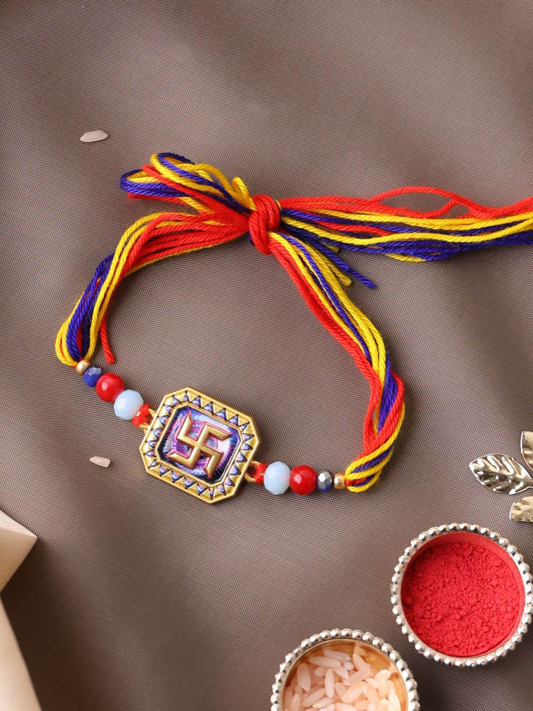 

PANASH Gold Plated Om Shaped Beaded Thread Rakhi With Roli Chawal