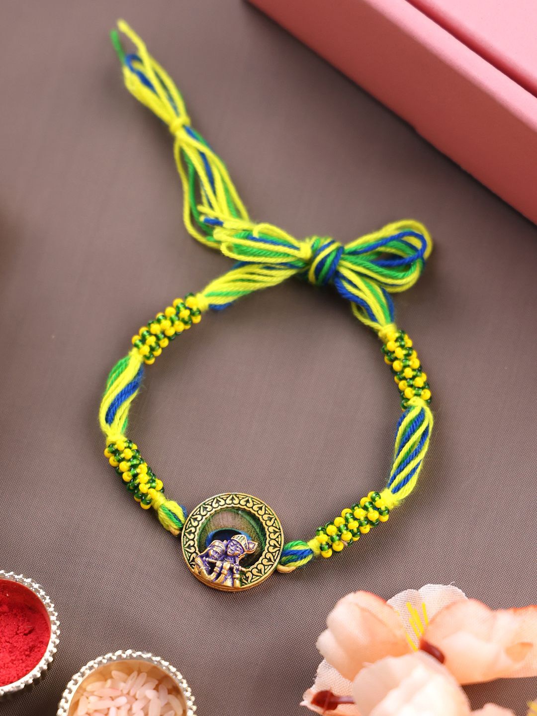

PANASH Gold Plated Krishna Shaped Thread Rakhi With Roli Chawal
