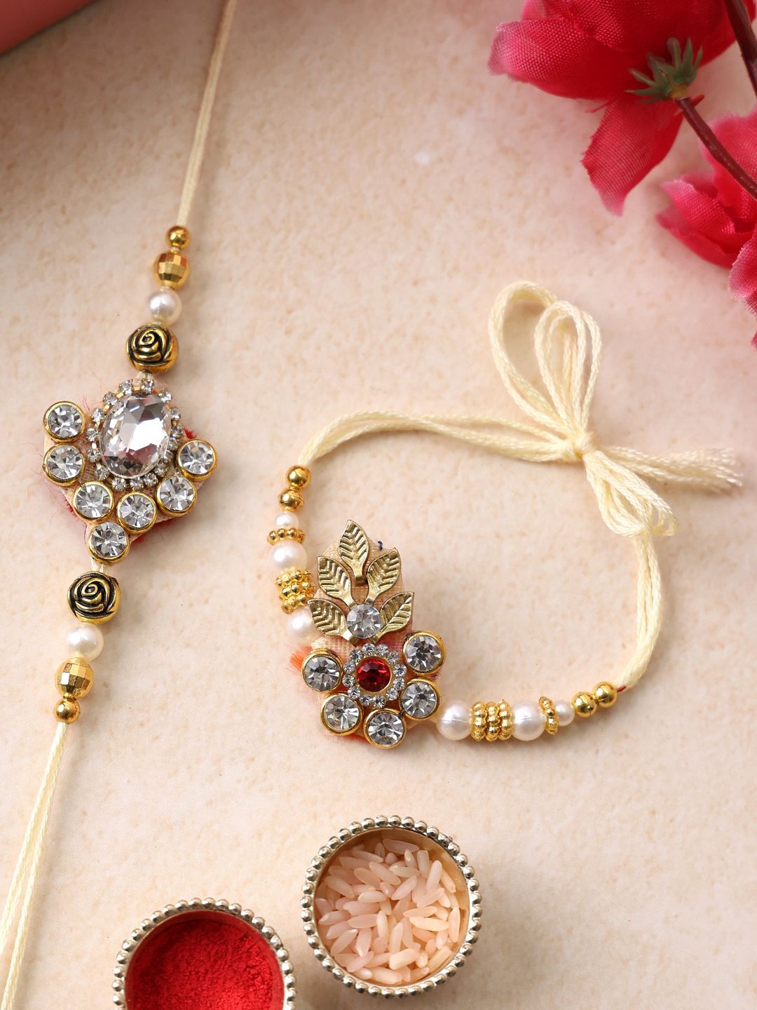 

PANASH Set Of 2 Gold Plated Floral Shaped Rakhis with Roli Chawal With Roli Chawal