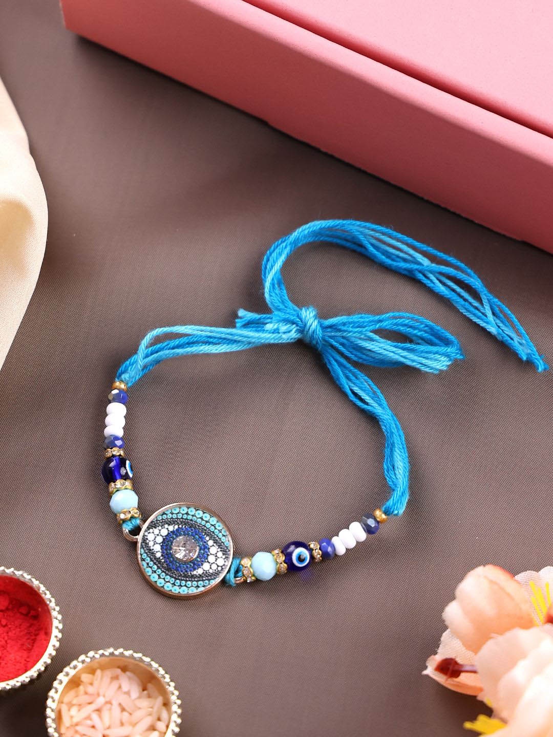 

PANASH Gold Plated Evil Eye With Stone Studded Thread Rakhi With Roli Chawal
