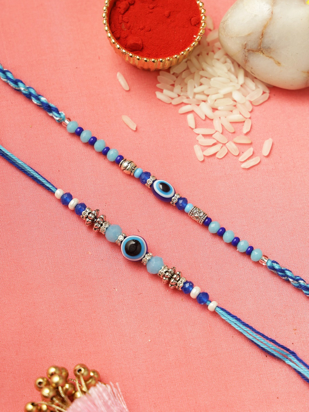 

Aapno Rajasthan Set of 2 Evil Eye Rakhis with Roli Chawal & Greetings Card, Blue