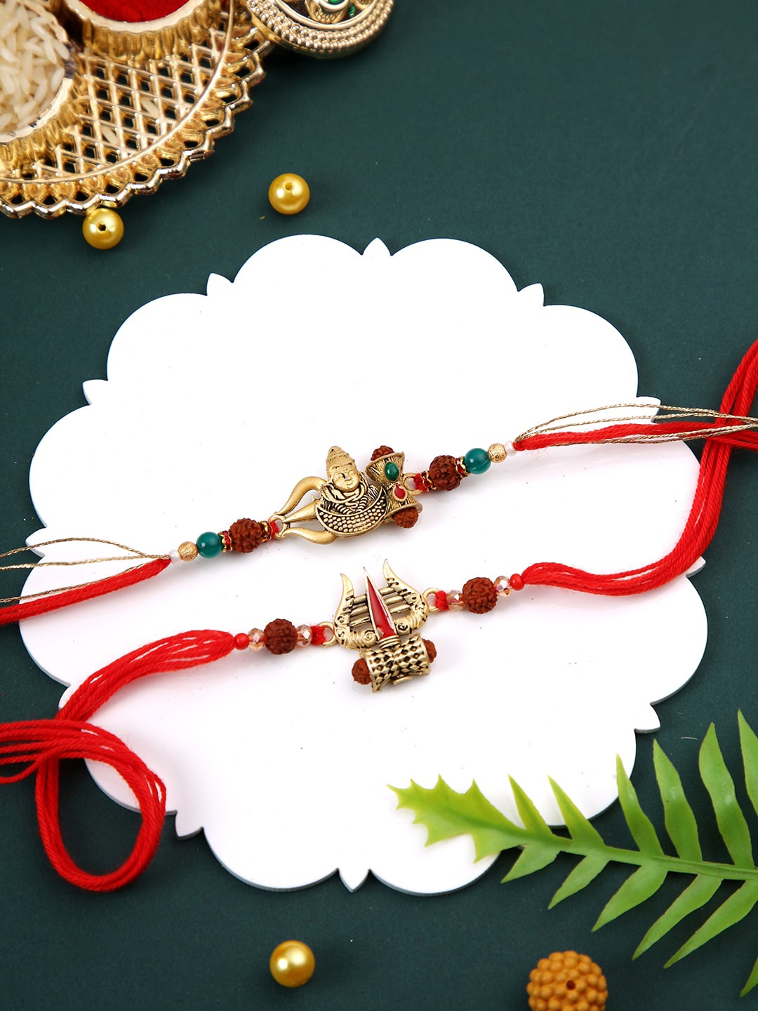 

Aapno Rajasthan Set of 2 Divine Shiva Trident Rakhi with Roli Chawal & Greeting Card, Red