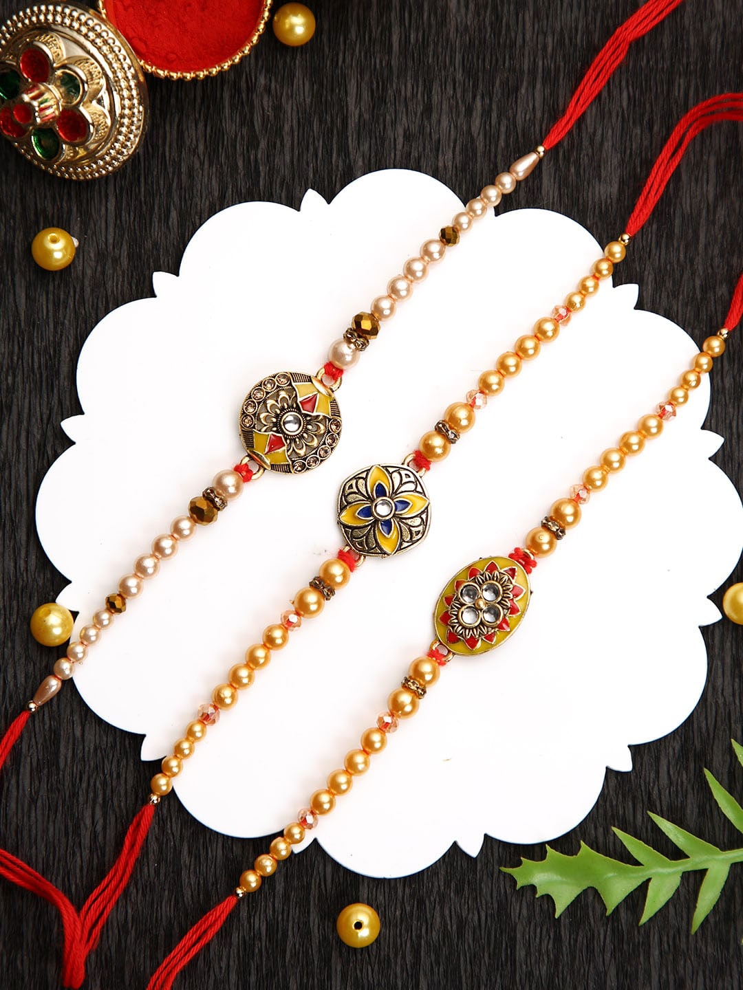 

Aapno Rajasthan Set of 3 Beaded Rakhi with Roli Chawal & Greeting Card, Gold