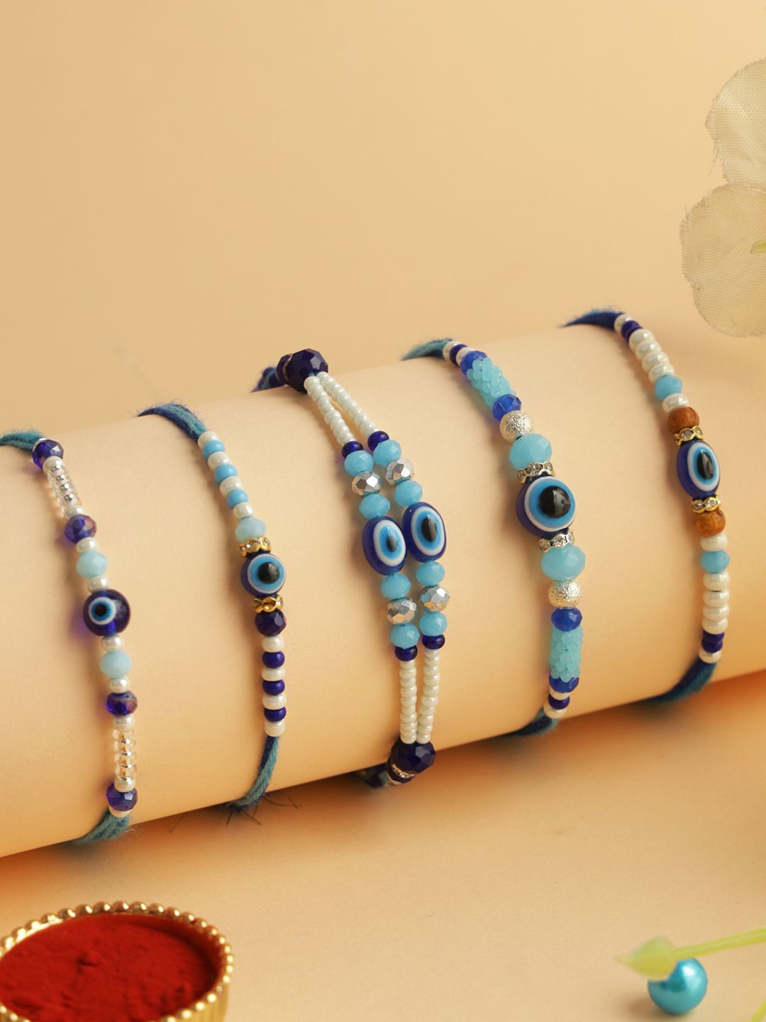 

Aapno Rajasthan Set of 5 Evil Eye Beaded Rakhi with Roli Chawal & Greeting Card, Blue