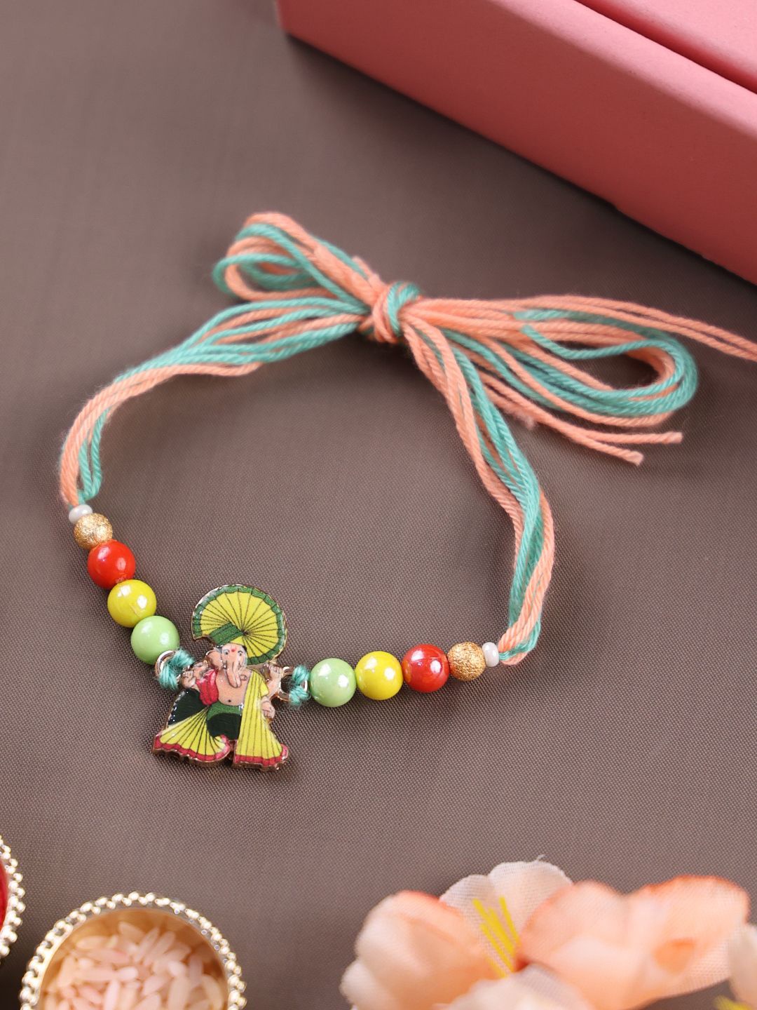 

PANASH Gold Plated Ganesh Temple Shaped Thread Rakhi With Roli Chawal