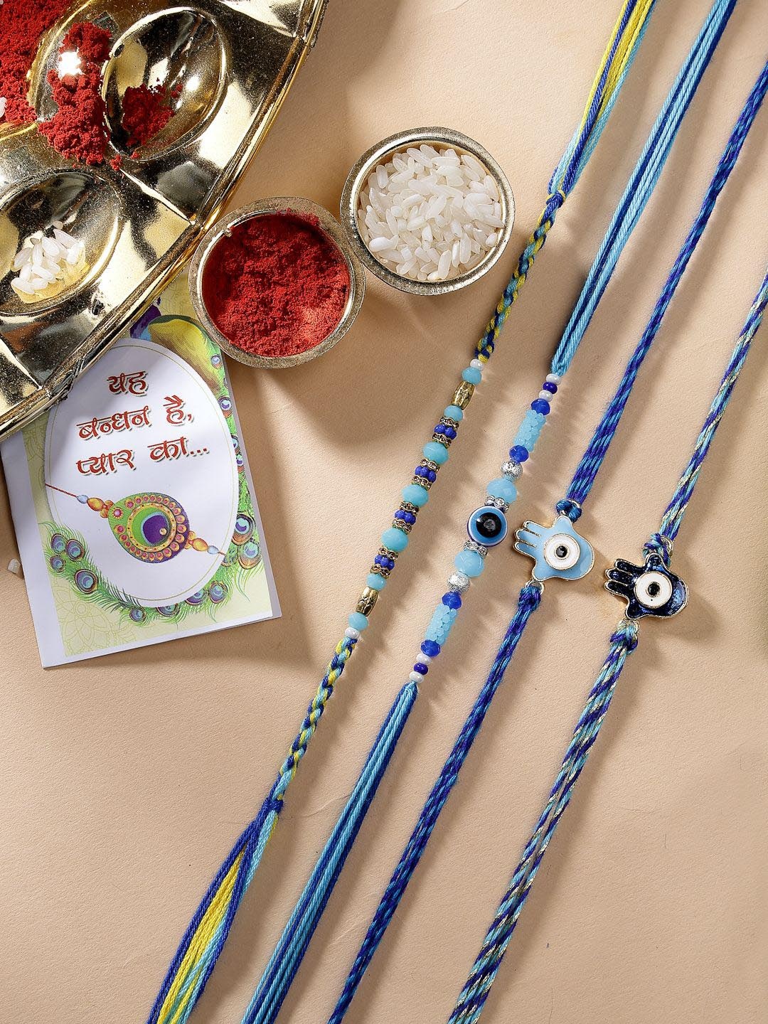 

NVR Set of 4 Evil Eye Charm & Beaded Thread Rakhis With Roli Chawal, Blue