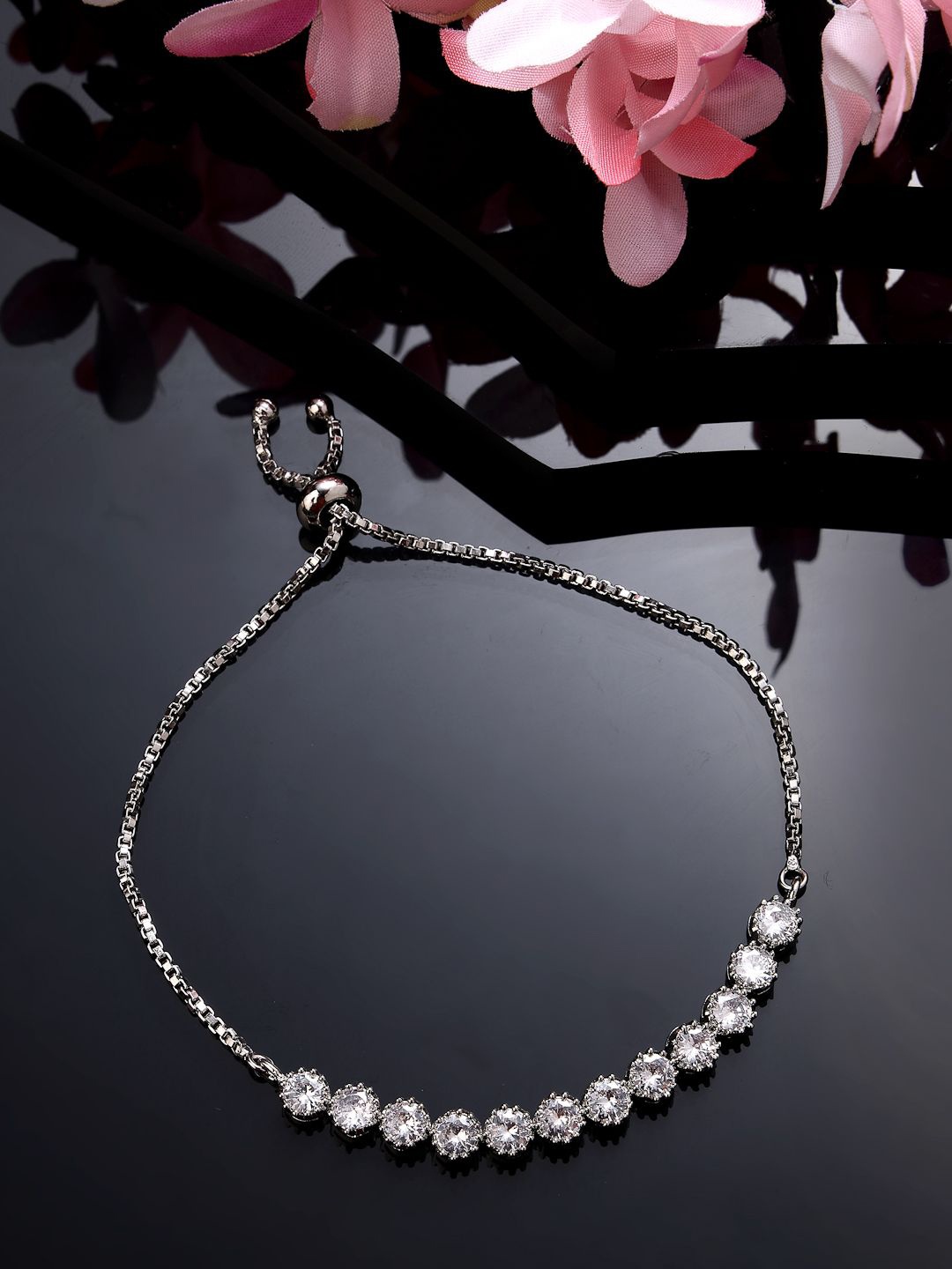 

NVR Silver-Plated American Diamond Studded Rakhi With Roli Chawal