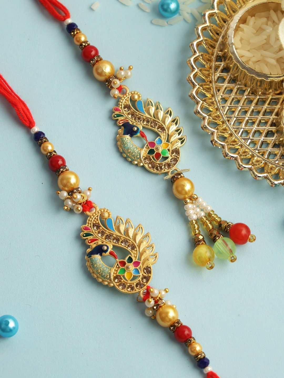 

Aapno Rajasthan Peacock Bead Work Bhaiya Bhabhi Rakhi With Roli Chawal & Greetings Card, Red