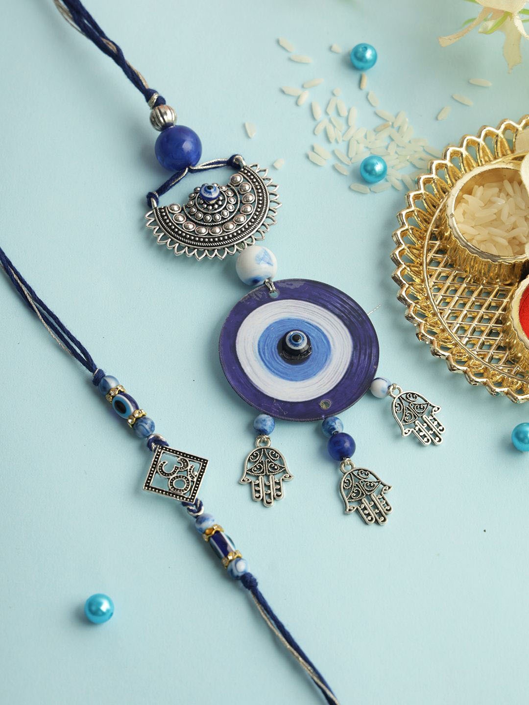 

Aapno Rajasthan Set of 2 Evil Eye Bhaiya Bhabhi Rakhi with Roli Chawal & Greeting Card, Silver