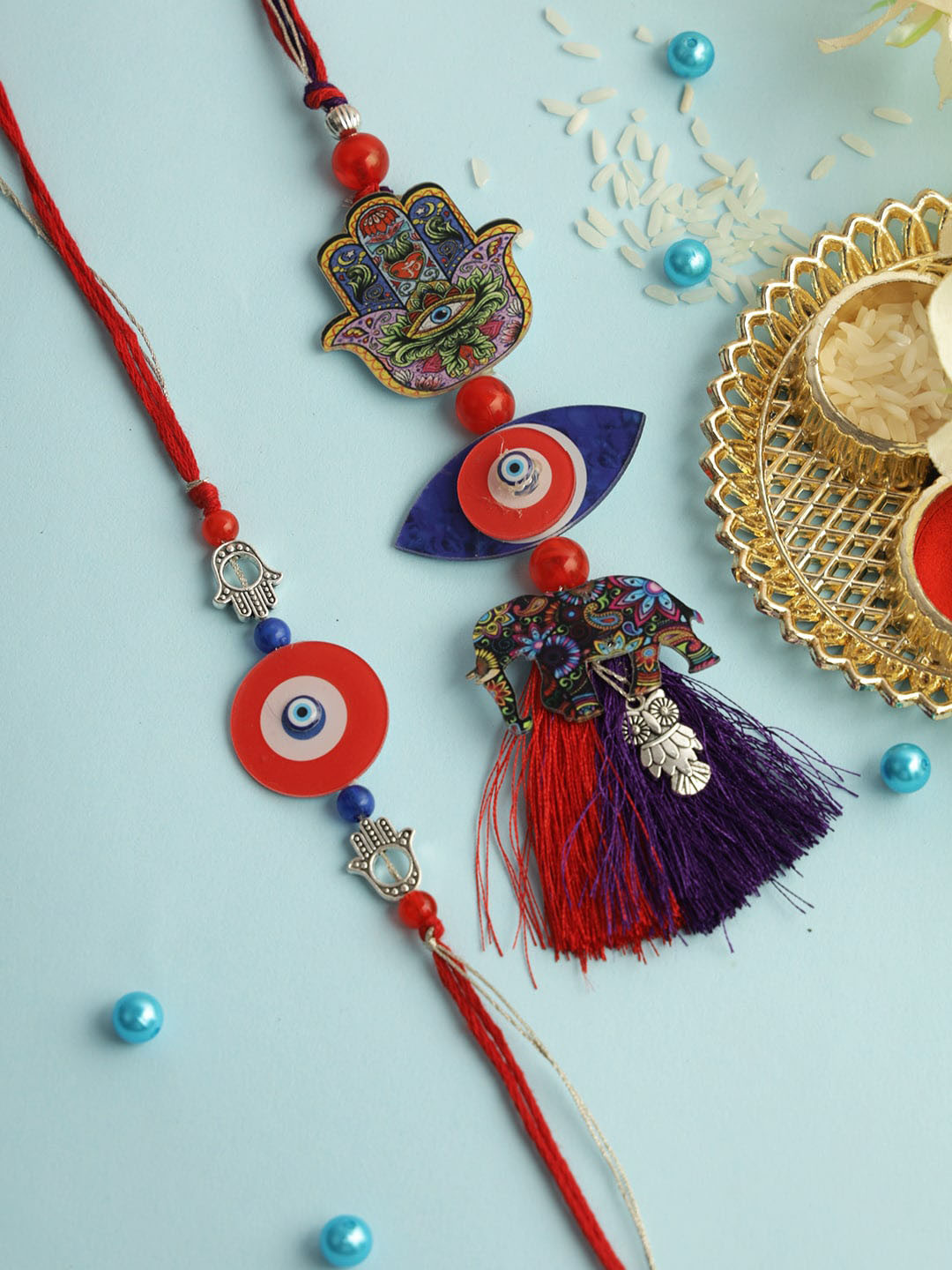 

Aapno Rajasthan Beaded Thread Rakhi with Roli Chawal & Greetings Card, Red