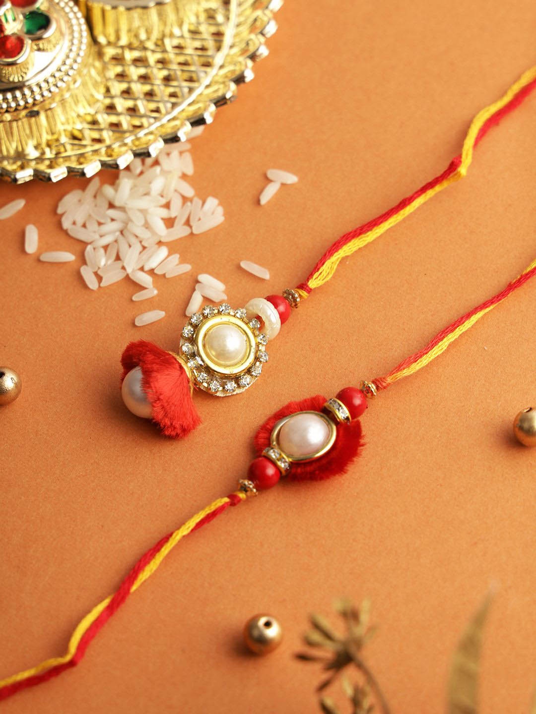

Aapno Rajasthan Set of 2 Beaded Thread Rakhi with Roli Chawal & Greetings Card, Red