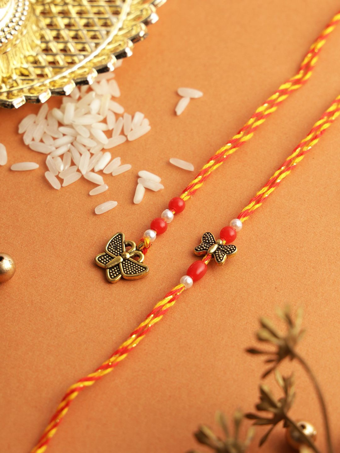 

Aapno Rajasthan Set of 2 Beaded Thread Rakhi with Roli Chawal & Greetings Card, Red