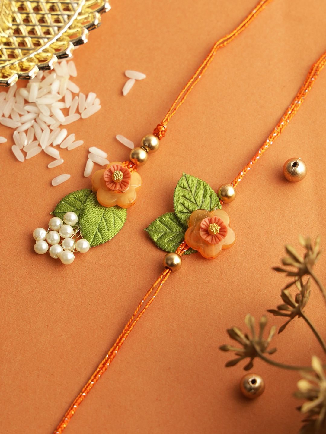 

Aapno Rajasthan Beaded & Floral Bhaiya Bhabhi Rakhi With Roli Chawal & Greetings Card, Orange