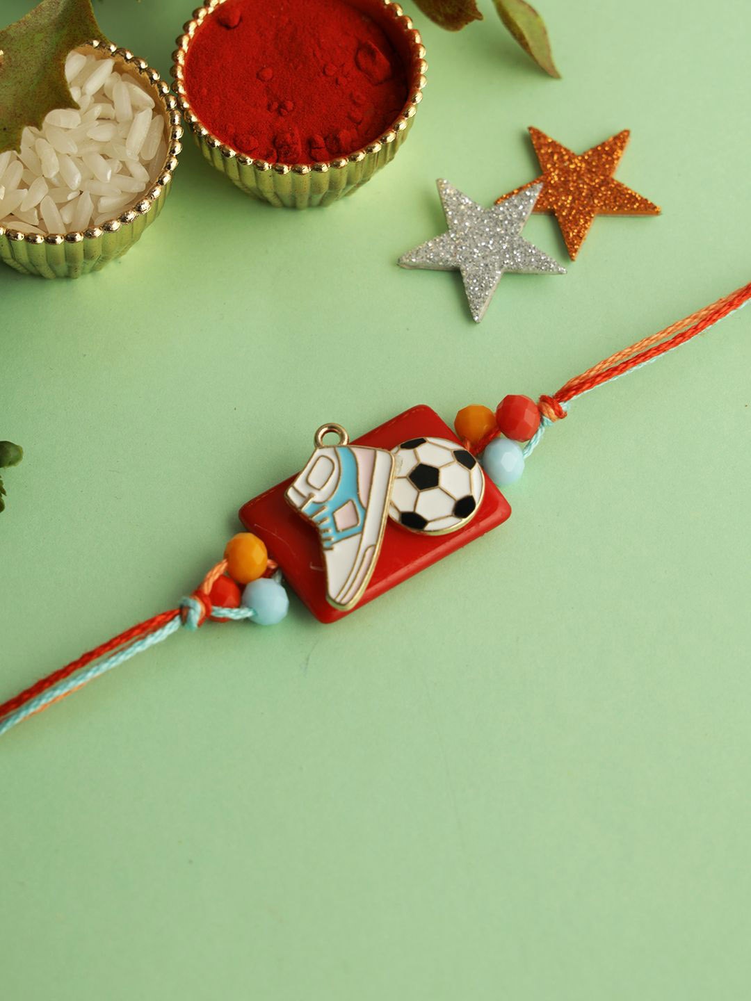 

Aapno Rajasthan Shoe & Football Designed Rakhi With Roli Chawal & Greetings Card, White