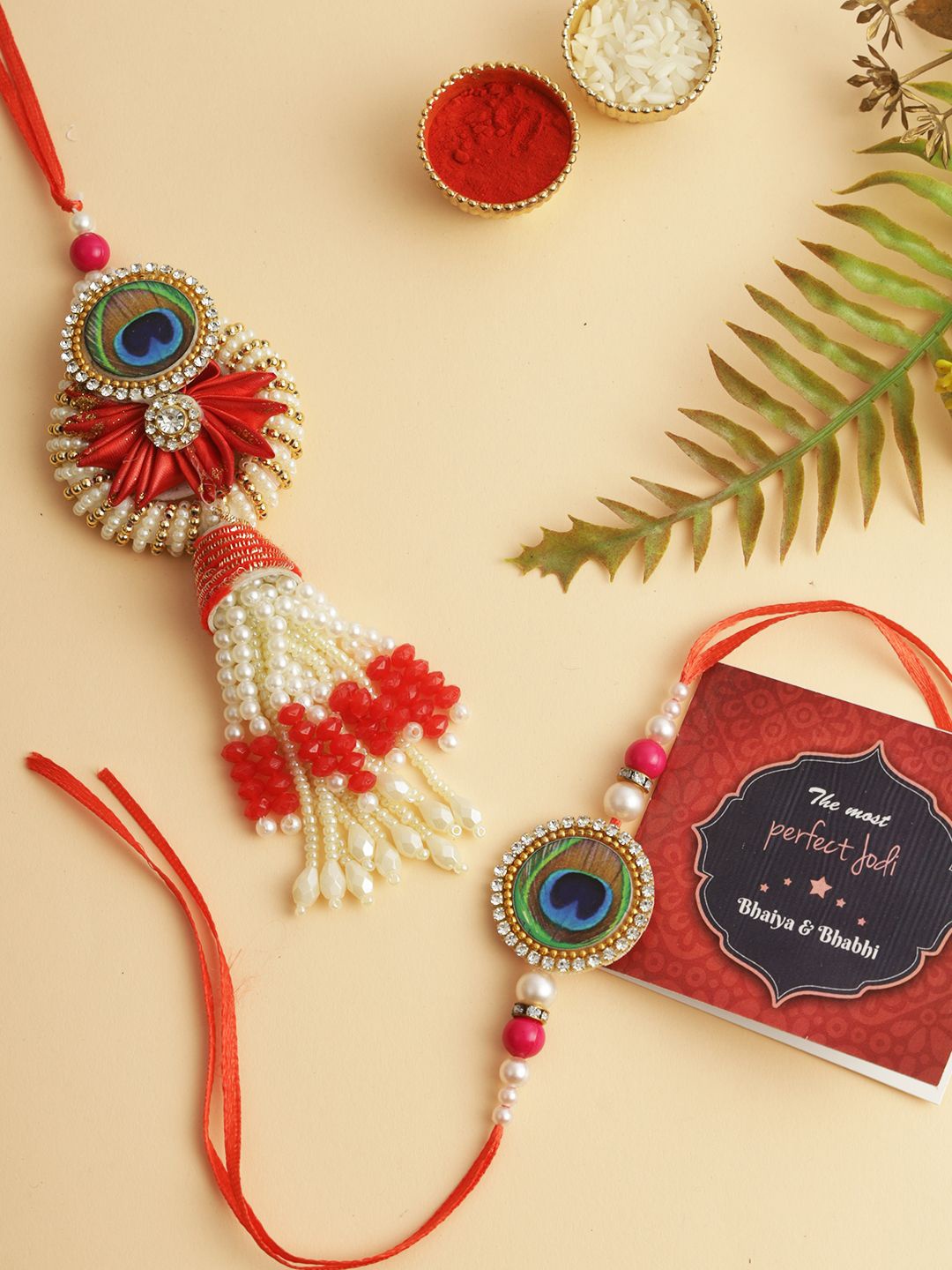 

TIED RIBBONS Set of 2 Bhaiya Bhabhi Peacock Rakhi with Card and Roli Chawal Gift, Red