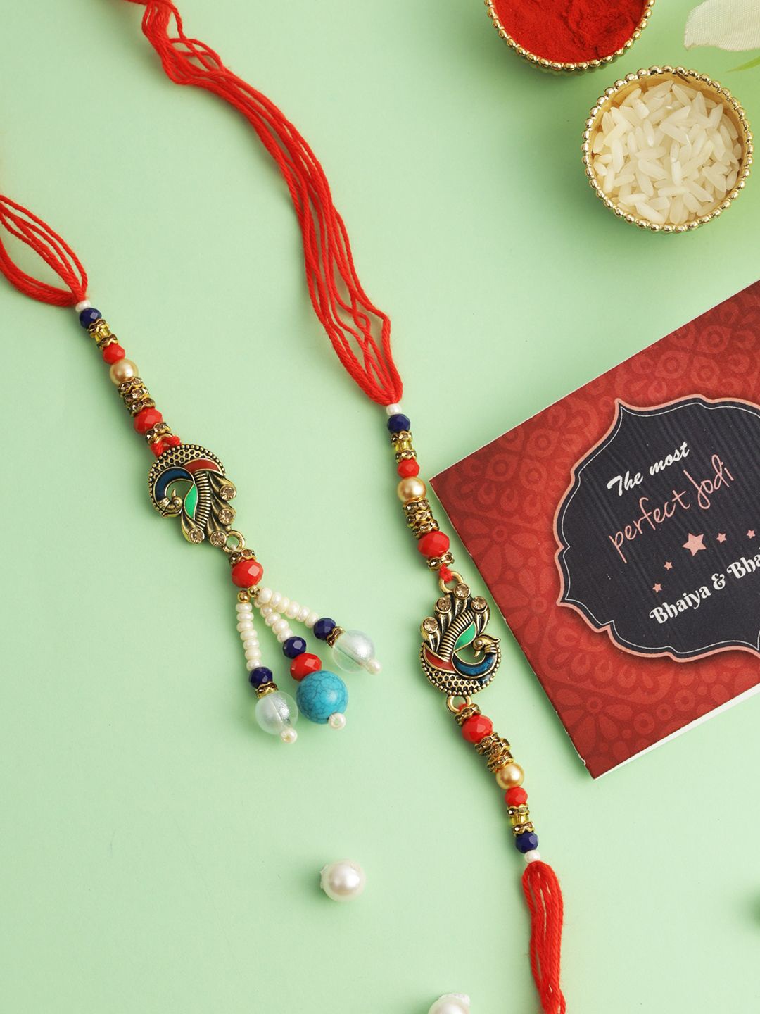 

TIED RIBBONS Set of 2 Handmade Peacock Rakhi Bhaiya Bhabhi, Card Combo, Red