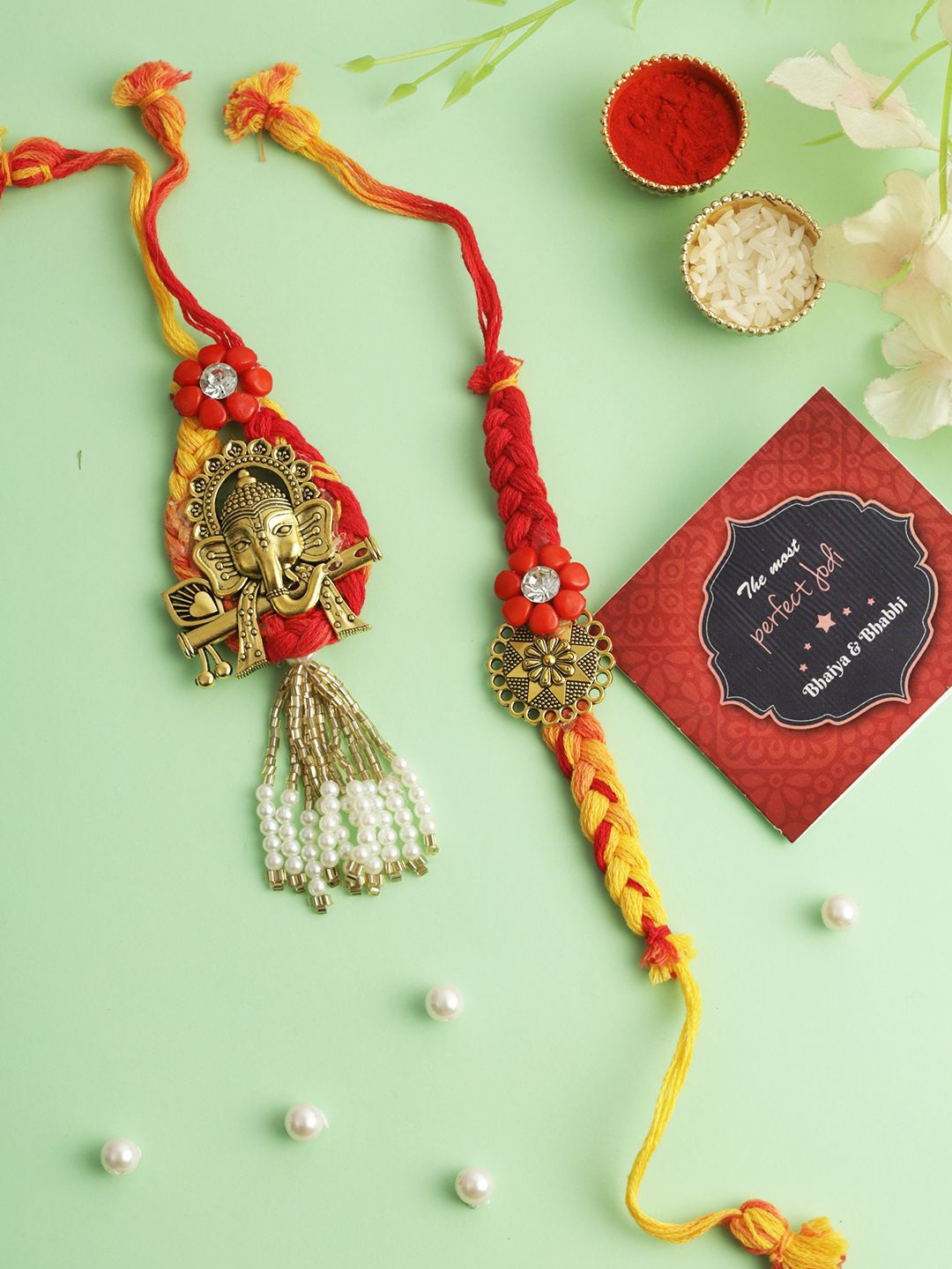 

TIED RIBBONS Set of 2 Bhaiya Bhabhi Couple Ganesh Rakhi with Card Gift, Gold