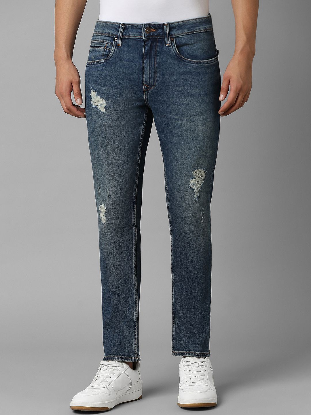 

Louis Philippe Jeans Men Slim Fit Mildly Distressed Light Fade Pure Cotton Ripped Jeans, Navy blue