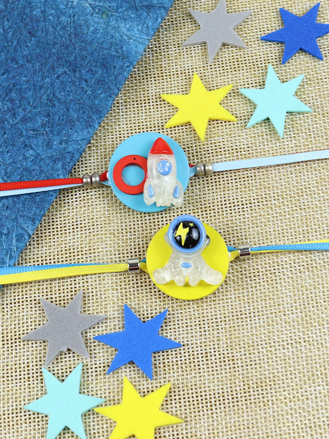 

Asthetika Boys Set Of 2 Astronaut & Rocket Thread Rakhis with Roli Chawal, Blue