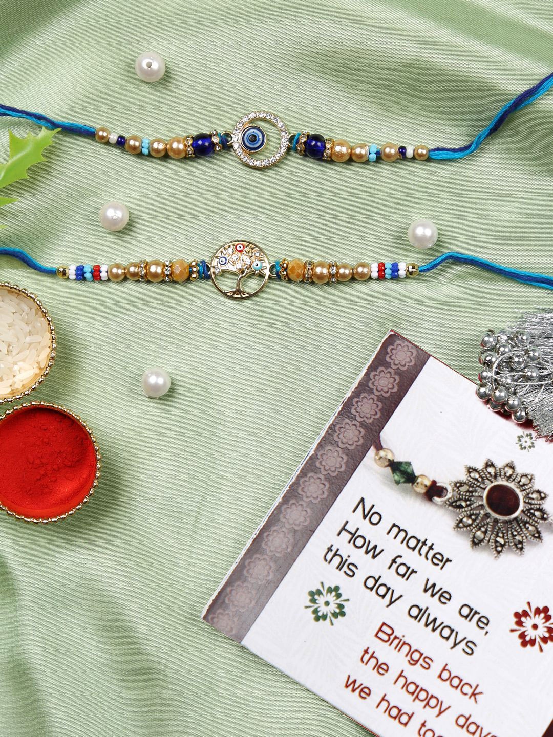 

TIED RIBBONS Set of 2 Evil Eye Rakhi with Card & Roli Chawal Combo, Gold