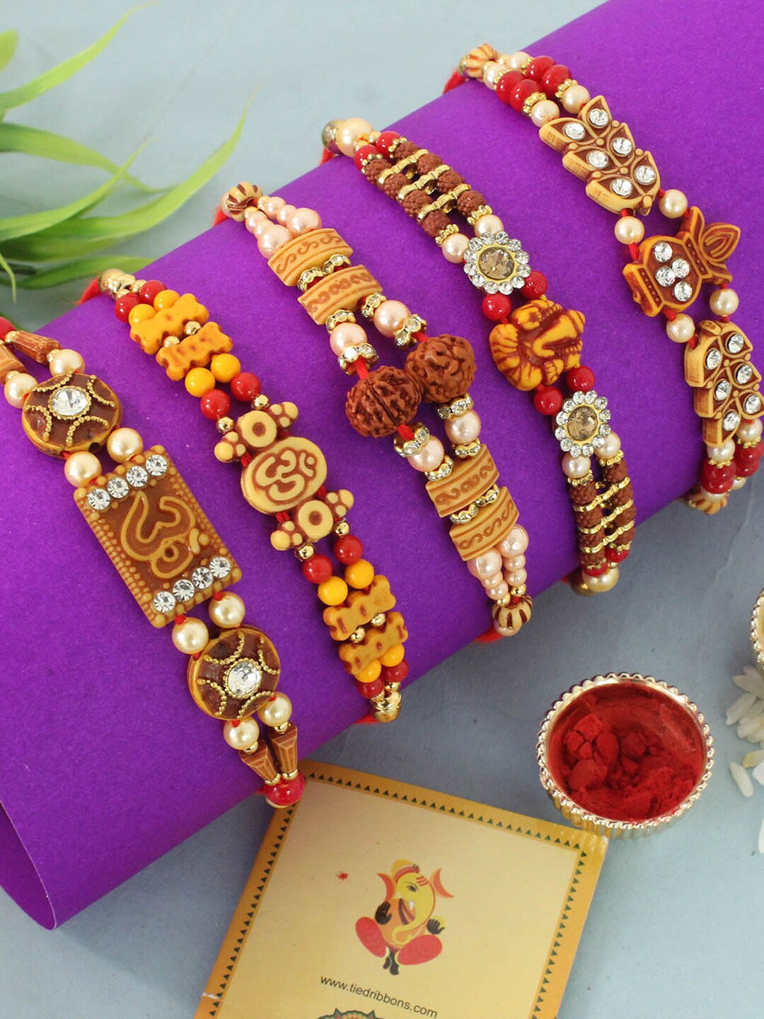 

TIED RIBBONS Set of 5 Rudraksha Rakhis with Card & Roli Chawal Combo, Red