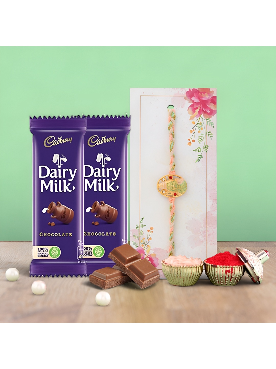 

Ascension Rakhi With Cedbury Dairy Milk Chocolates & Roli Tilak, Blue