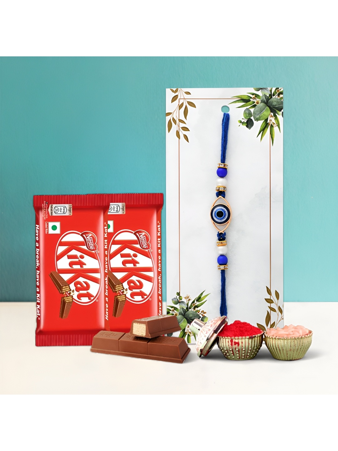 

Ascension Beaded Rakhi With Kitkat Chocolates & Greeting Card With Roli Chawal, Blue