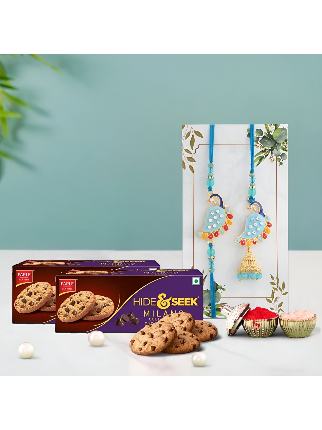 

Ascension Set Of 2 Rakhis With Milano Cookies With Rholi Chawal, Blue