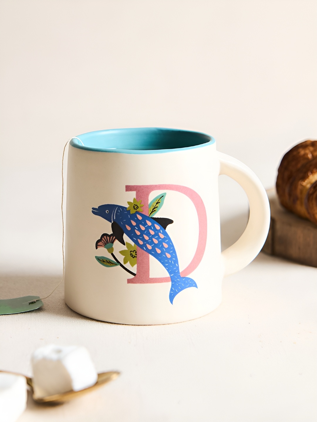 

Chumbak Off White & Blue Printed Ceramic Glossy Mug 300 ml